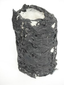 Stained porcelain over magazine paper.