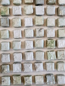 a square of 100 tiny porcelain boxes.  Representing repetition of days.